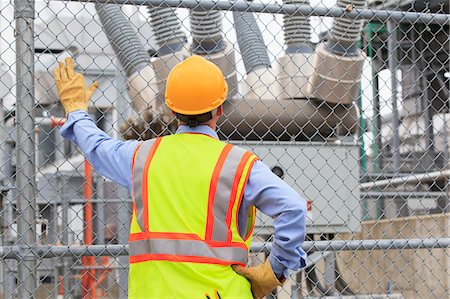 Electrical engineer examining transformers inside of an electric power plant Stock Photo - Premium Royalty-Free, Code: 6105-07521451