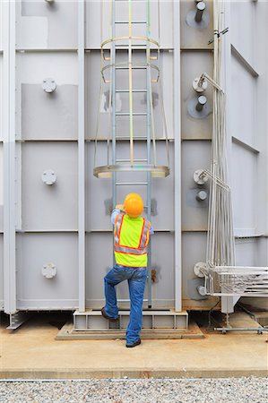 Engineer at sound suppression stage of gas turbine which drives generators in power plant while turbine is powered down Stock Photo - Premium Royalty-Free, Code: 6105-07521473