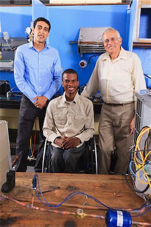 Instructor and two students in HVAC and process control classroom one student in wheelchair Stock Photo - Premium Royalty-Free, Code: 6105-07521499