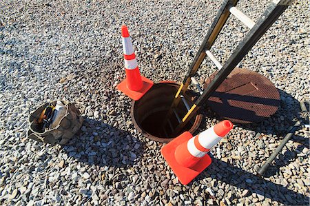 Ladder in manhole and warning cones at high voltage power distribution station, Braintree, Massachusetts, USA Stock Photo - Premium Royalty-Free, Code: 6105-07521412