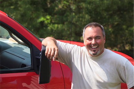 Landscaper smiling next to his truck Stock Photo - Premium Royalty-Free, Code: 6105-07521424