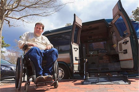 Man with Spinal Cord Injury opening his accessible van remotely Stock Photo - Premium Royalty-Free, Code: 6105-07744503