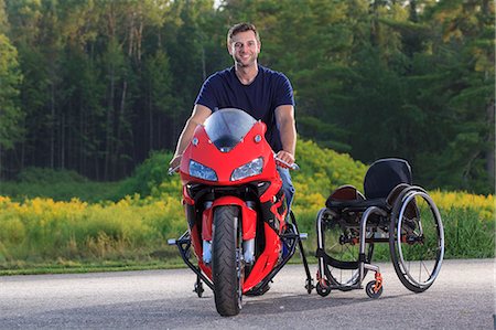 Man with spinal cord injury on his custom adaptive motorcycle Stock Photo - Premium Royalty-Free, Code: 6105-08211269