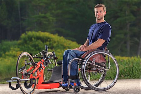 Man with spinal cord injury in his wheelchair with his custom adaptive hand cycle Stock Photo - Premium Royalty-Free, Code: 6105-08211280