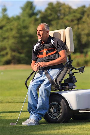 Man with a spinal cord injury in an adaptive cart about to play golf Stock Photo - Premium Royalty-Free, Code: 6105-08211336