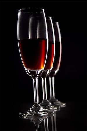 extremism - Close-up of three glasses of wine against black background Stock Photo - Premium Royalty-Free, Code: 6107-06117562