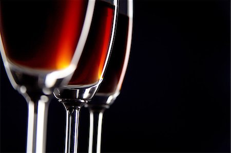 extremism - Close-up of three glasses of wine against black background Stock Photo - Premium Royalty-Free, Code: 6107-06117564