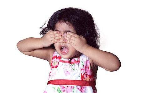 Portrait of a young girl covering her eyes with her hands Stock Photo - Premium Royalty-Free, Code: 6107-06117584