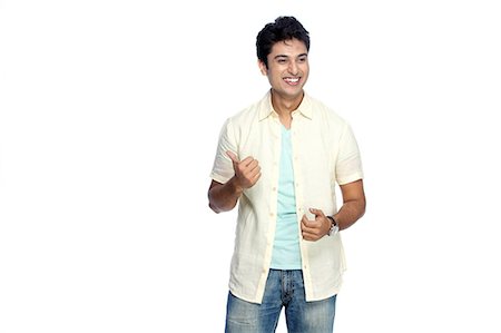 Portrait of young smiling man posing Stock Photo - Premium Royalty-Free, Code: 6107-06117653