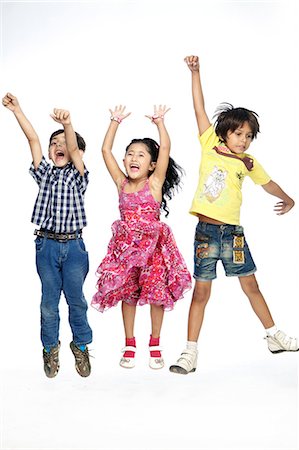 Portrait of three children dancing Stock Photo - Premium Royalty-Free, Code: 6107-06117775