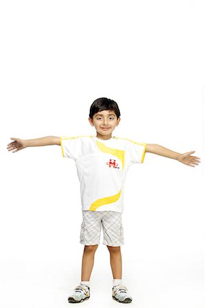 Portrait of a boy standing with hands stretched Stock Photo - Premium Royalty-Free, Code: 6107-06117858