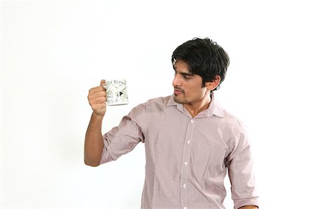 Portrait of man Looking at coffee cup Stock Photo - Premium Royalty-Free, Code: 6107-06117946