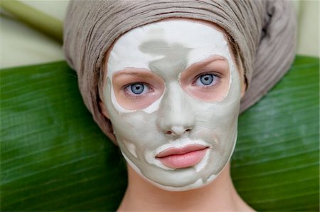 Portrait of a young woman with beauty mask on her face Stock Photo - Premium Royalty-Free, Code: 6108-05855761