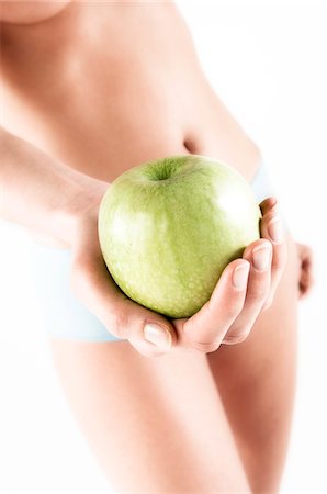 simsearch:6108-05855882,k - Naked woman in panties, holding a green apple, close up (studio) Stock Photo - Premium Royalty-Free, Code: 6108-05855861