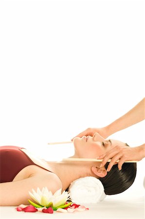 Woman having head massaged, water lily Stock Photo - Premium Royalty-Free, Code: 6108-05855973