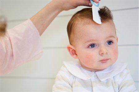 Woman combing her baby Stock Photo - Premium Royalty-Free, Code: 6108-05855988