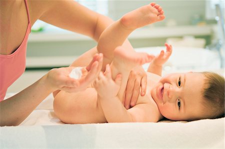 Mother and naked baby, milky cleanser in her hand Stock Photo - Premium Royalty-Free, Code: 6108-05856043