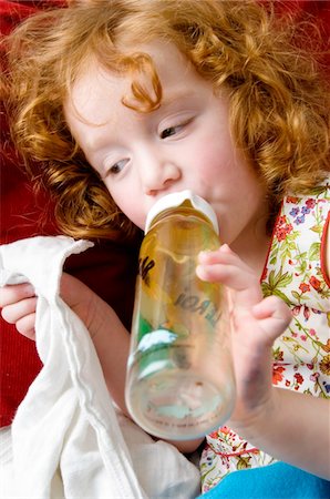 red head child - Little girl and baby's bottle Stock Photo - Premium Royalty-Free, Code: 6108-05856078