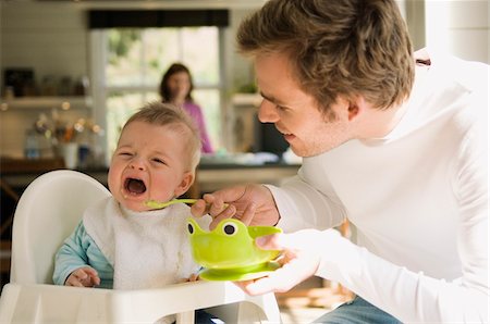 Father feeding her baby, crying Stock Photo - Premium Royalty-Free, Code: 6108-05856028