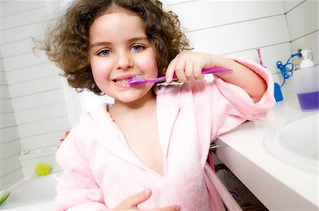 Little girl brushing her teeth Stock Photo - Premium Royalty-Free, Code: 6108-05856131