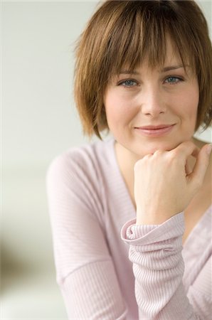 emotion - Young woman looking at the camera Stock Photo - Premium Royalty-Free, Code: 6108-05856438