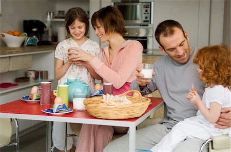 simsearch:6108-05856772,k - Couple and 2 little girls at breakfast table Stock Photo - Premium Royalty-Free, Code: 6108-05856650