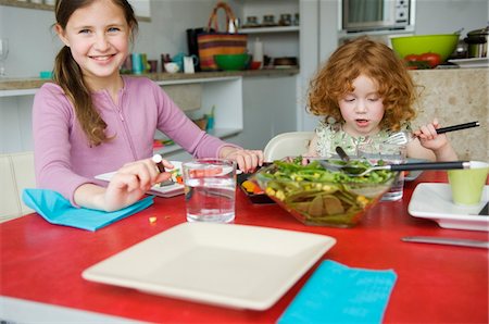 family salad - 2 little girls at lunch table Stock Photo - Premium Royalty-Free, Code: 6108-05856672