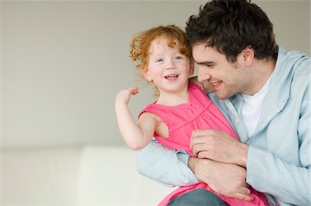 parent tickle child - Man and little girl embracing Stock Photo - Premium Royalty-Free, Code: 6108-05856694