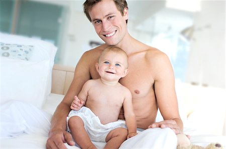 Father and baby smiling, indoors Stock Photo - Premium Royalty-Free, Code: 6108-05857941