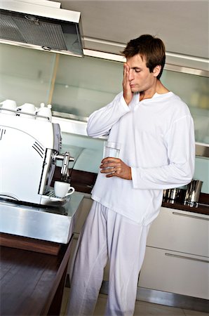 pyjamas (sleepwear with pants) - Man in kitchen preparing coffee, indoors Stock Photo - Premium Royalty-Free, Code: 6108-05857961