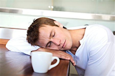 sleepy - Portrait of a man sleeping on table in kitchen, indoors Stock Photo - Premium Royalty-Free, Code: 6108-05857987