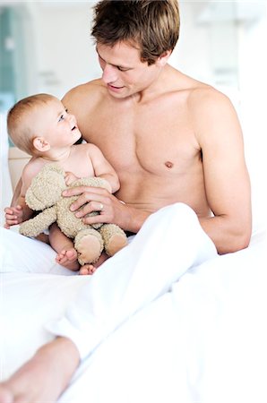 Father and baby sitting indoors Stock Photo - Premium Royalty-Free, Code: 6108-05857922