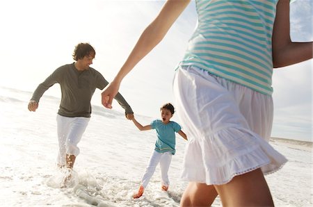 simsearch:6108-05858260,k - Couple and daughter walking in the sea, outdoors Stock Photo - Premium Royalty-Free, Code: 6108-05858139