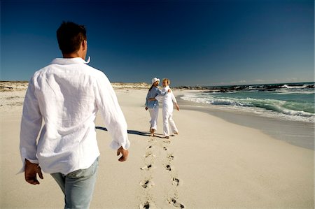 footsteps beach summer - Couple and senior woman walking on beach Stock Photo - Premium Royalty-Free, Code: 6108-05858206