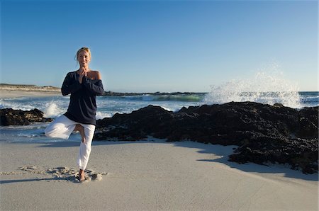 sky clothes - Young woman in yoga attitude on the beach, outdoors Stock Photo - Premium Royalty-Free, Code: 6108-05858472