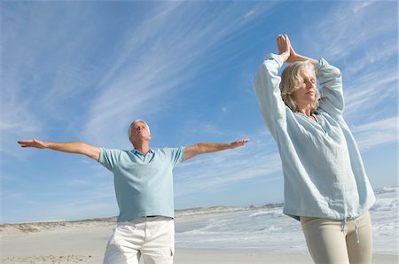 partner, concept - Couple in yoga attitude on the beach, outdoors Stock Photo - Premium Royalty-Free, Code: 6108-05858499