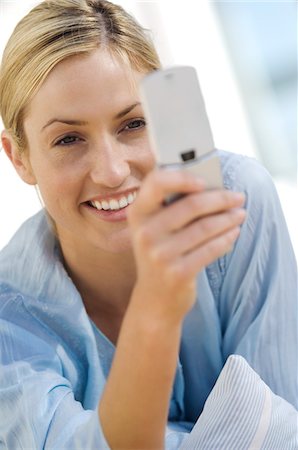 simsearch:6108-05857751,k - Young woman using mobile phone Stock Photo - Premium Royalty-Free, Code: 6108-05858645