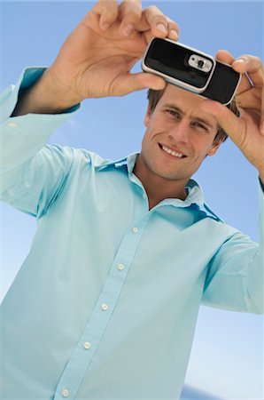 simsearch:6108-05857751,k - Portrait of a man using camera phone Stock Photo - Premium Royalty-Free, Code: 6108-05858621