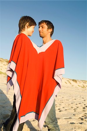 poncho - Couple on the beach, sharing a poncho Stock Photo - Premium Royalty-Free, Code: 6108-05858944