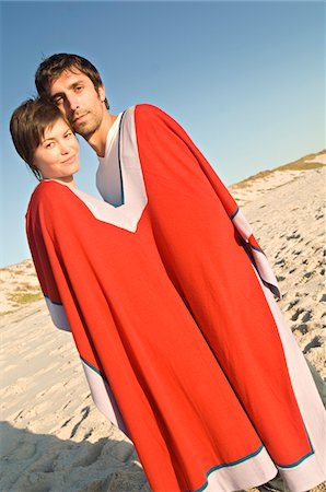 poncho - Couple on the beach, sharing a poncho Stock Photo - Premium Royalty-Free, Code: 6108-05859002