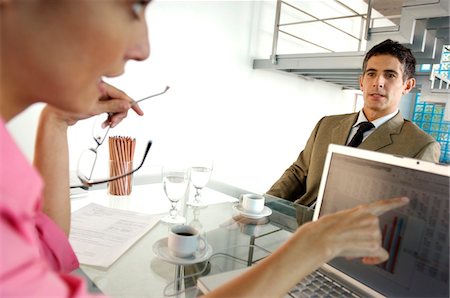 Businesswoman conversing with businessman in office Stock Photo - Premium Royalty-Free, Code: 6108-05859479