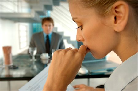 Businesswoman in office with colleague in background Stock Photo - Premium Royalty-Free, Code: 6108-05859407