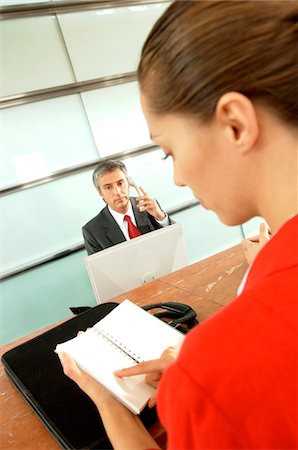 Mature businessman and female executive in office Stock Photo - Premium Royalty-Free, Code: 6108-05859412