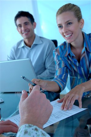 Businesswoman and businessman in office, smiling Stock Photo - Premium Royalty-Free, Code: 6108-05859422