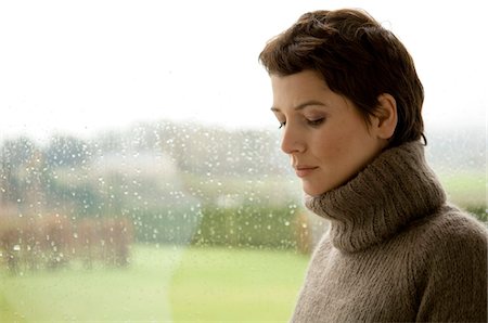 rainy window - Mid adult woman looking serious Stock Photo - Premium Royalty-Free, Code: 6108-05859750