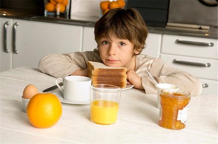 simsearch:6108-05864945,k - Portrait of a boy having breakfast Stock Photo - Premium Royalty-Free, Code: 6108-05859854