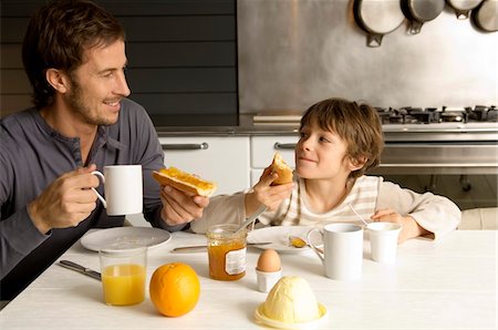 simsearch:6108-05864945,k - Mid adult man having breakfast with his son Stock Photo - Premium Royalty-Free, Code: 6108-05859861