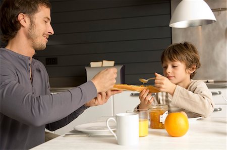 simsearch:6108-05864945,k - Mid adult man and his son having breakfast Stock Photo - Premium Royalty-Free, Code: 6108-05859872