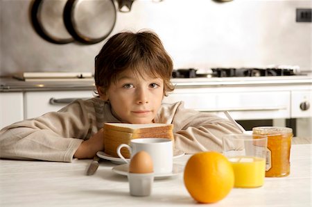 simsearch:6108-05864945,k - Portrait of a boy having breakfast Stock Photo - Premium Royalty-Free, Code: 6108-05859880