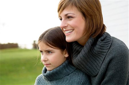 simsearch:6108-05859747,k - Close-up of a young woman hugging her daughter and smiling Stock Photo - Premium Royalty-Free, Code: 6108-05859832